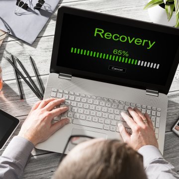 man on laptop recovery bar on screen online backup